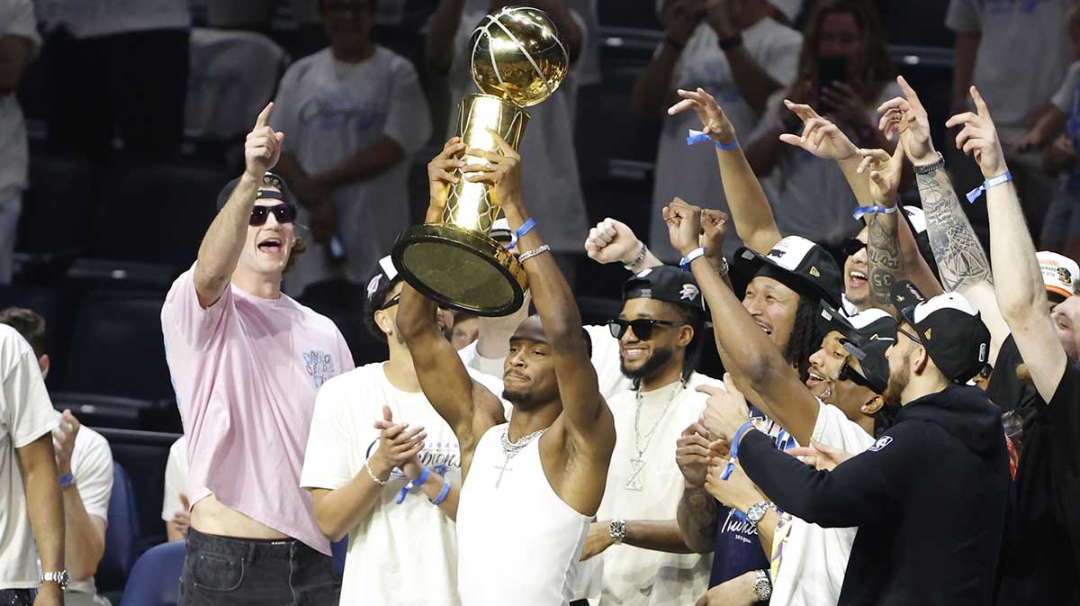 Oklahoma City Thunder guard Shai Gilgeous-Alexander (2) holds up the Larry OíBrien Championship Trophy during the Champions Opening Ceremony for the parade inside the Paycom Center.