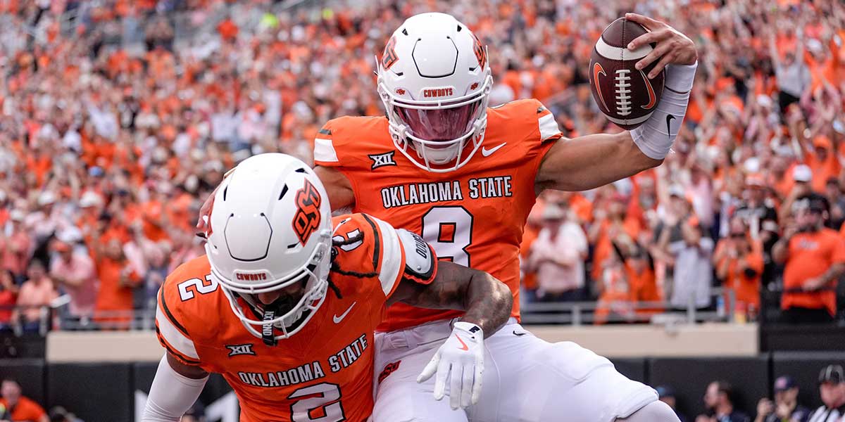 Oklahoma State quarterback Hauss Hejny (8) runs the ball for a touchdown and celebrates with Oklahoma State wide receiver Terrill Davis (2) in the first quarter during an NCAA football game between Oklahoma State (OSU) and UT Martin in Stillwater, Okla., on Thursday, Aug. 28, 2025.