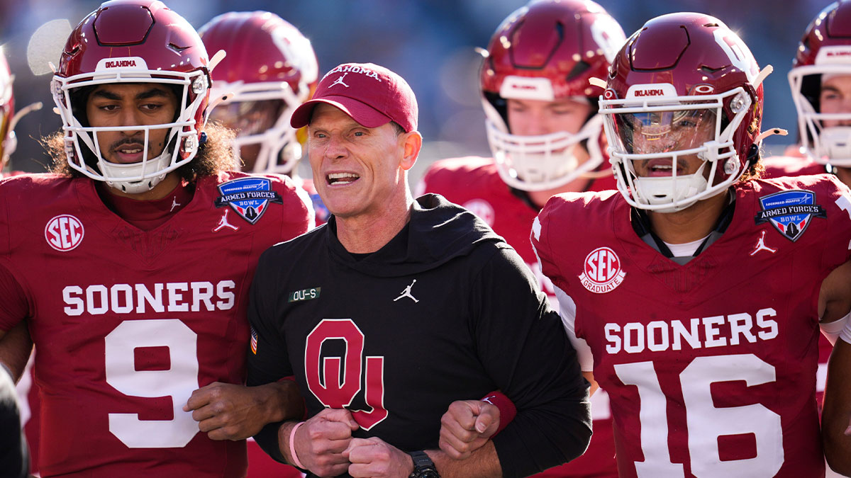 Oklahoma coach Brent Venables locks arms with players before the Armed Forces Bowl football game between the University of Oklahoma Sooners (OU) and the Navy Midshipmen at Amon G. Carter Stadium in Fort Worth, Texas, Friday, Dec. 27, 2024. Navy won 21-20.