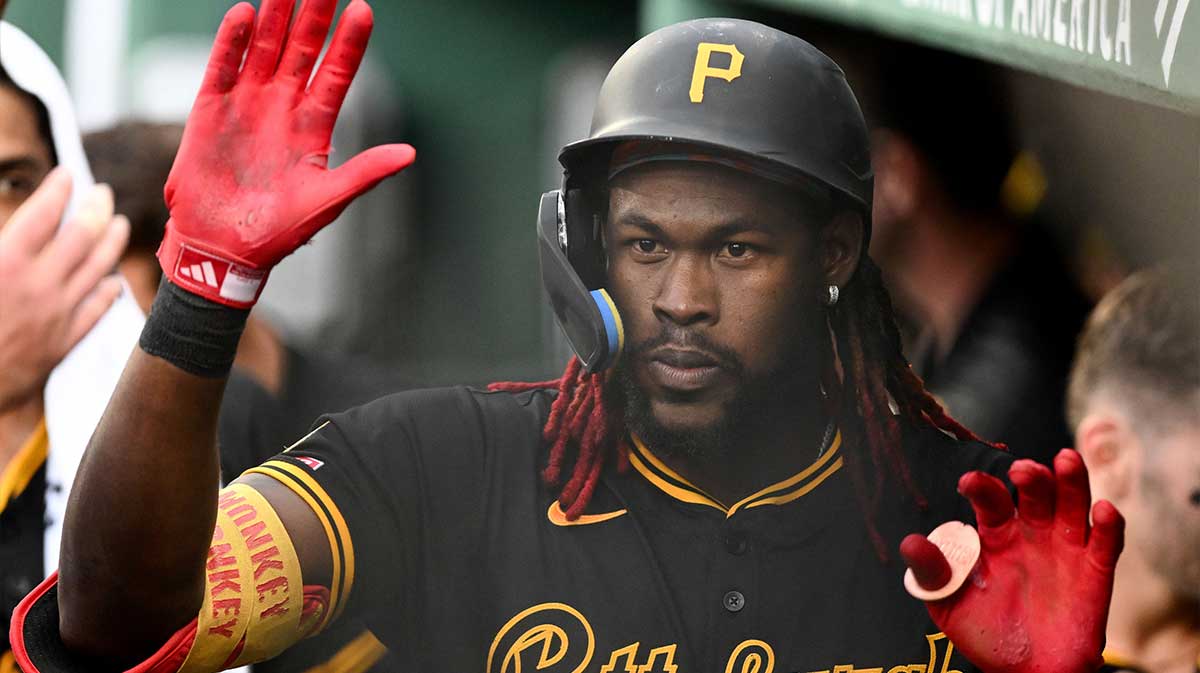 Pittsburgh Pirates center fielder Oneil Cruz (15) high-fives his teammates after hitting a solo home run against the Boston Red Sox during the fifth inning at Fenway Park.