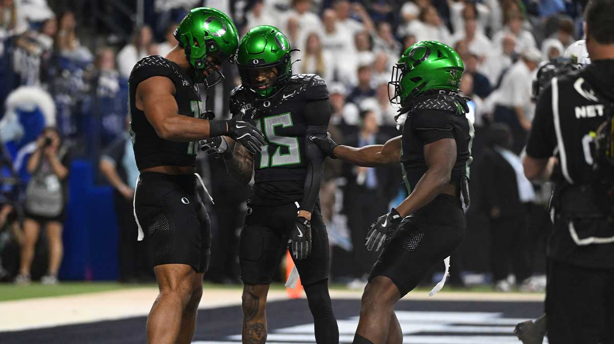 Oregon Ducks tight end Kenyon Sadiq (18), wide receiver Tez Johnson (15) and running back Noah Whittington (6) celebrate a touchdown against the Penn State Nittany Lions during the third quarter in the 2024 Big Ten Championship game at Lucas Oil Stadium.