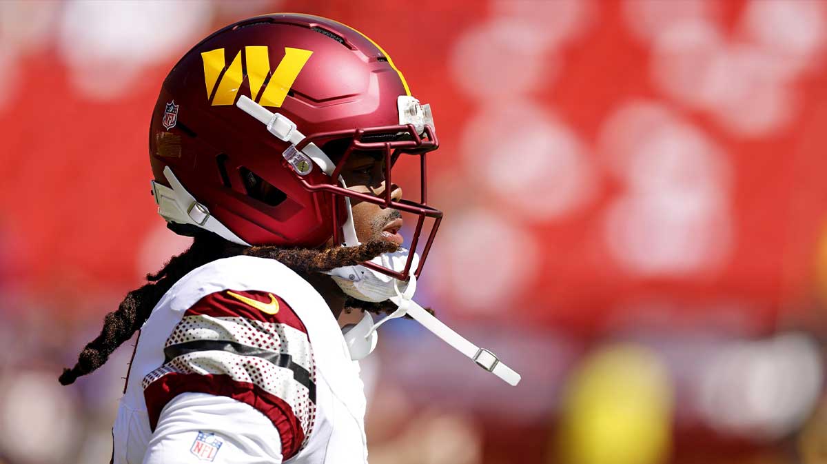Washington Commanders wide receiver K.J. Osborn (13) warms up before playing against the Baltimore Ravens at Northwest Stadium.
