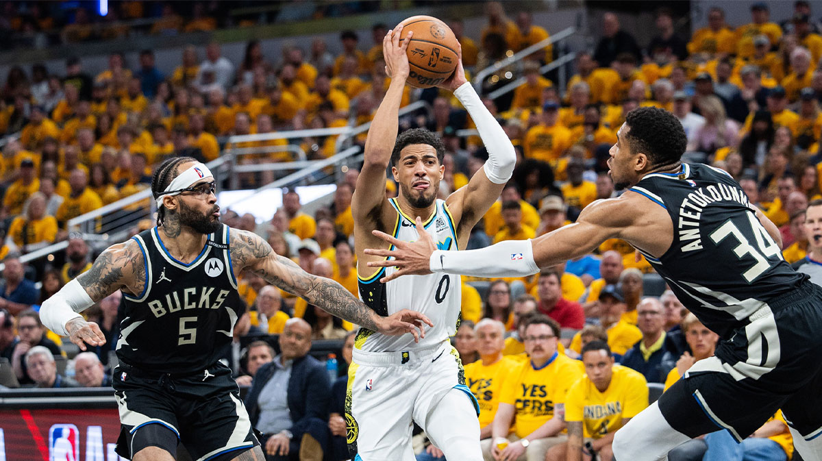 Indiana Pacers guard Tyrese Haliburton (0) shoots the ball while Milwaukee Bucks guard Gary Trent Jr. (5) and forward Giannis Antetokounmpo (34) defend during game five of the first round for the 2024 NBA Playoffs at Gainbridge Fieldhouse.