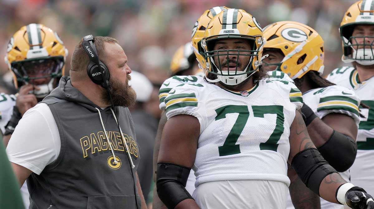 Green Bay Packers offensive tackle Jordan Morgan (77) listens to offensive line coach Luke Butkus during the first quarter of their preseason game Saturday, August 23, 2025 at Lambeau Field in Green Bay, Wisconsin. The Green Bay Packers beat the Seattle Seahawks 20-7.