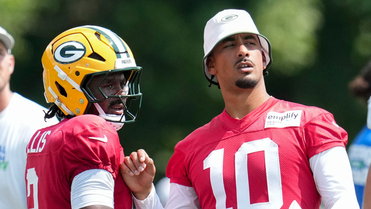 Green Bay Packers quarterback Jordan Love (10) speaks with quarterback Malik Willis (2) on Thursday, Aug. 14, 2025, at a joint practice with the Indianapolis Colts during the Colts’ training camp at Grand Park in Westfield. Packers quarterback Jordan Love eyes cautious NFL preseason return after thumb surgery, using a “different” strategy to protect the injury.