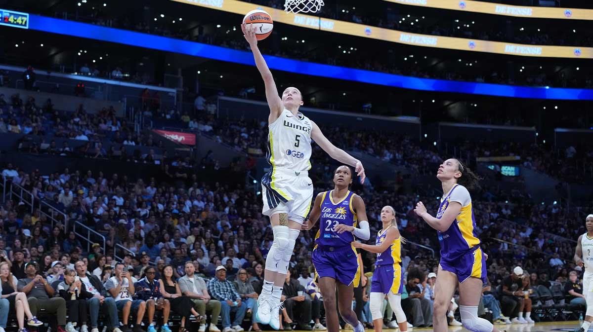Dallas Wings guard Paige Bueckers (5) shoots the ball against LA Sparks forward Dearica Hamby (5) and forward Azura Stevens (23) in the first half at Crypto.com Arena.
