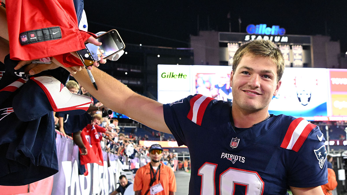 Patriots quarterback Drake Maye (10) signs autographs after a game against the Washington Commanders during the second half at Gillette Stadium
