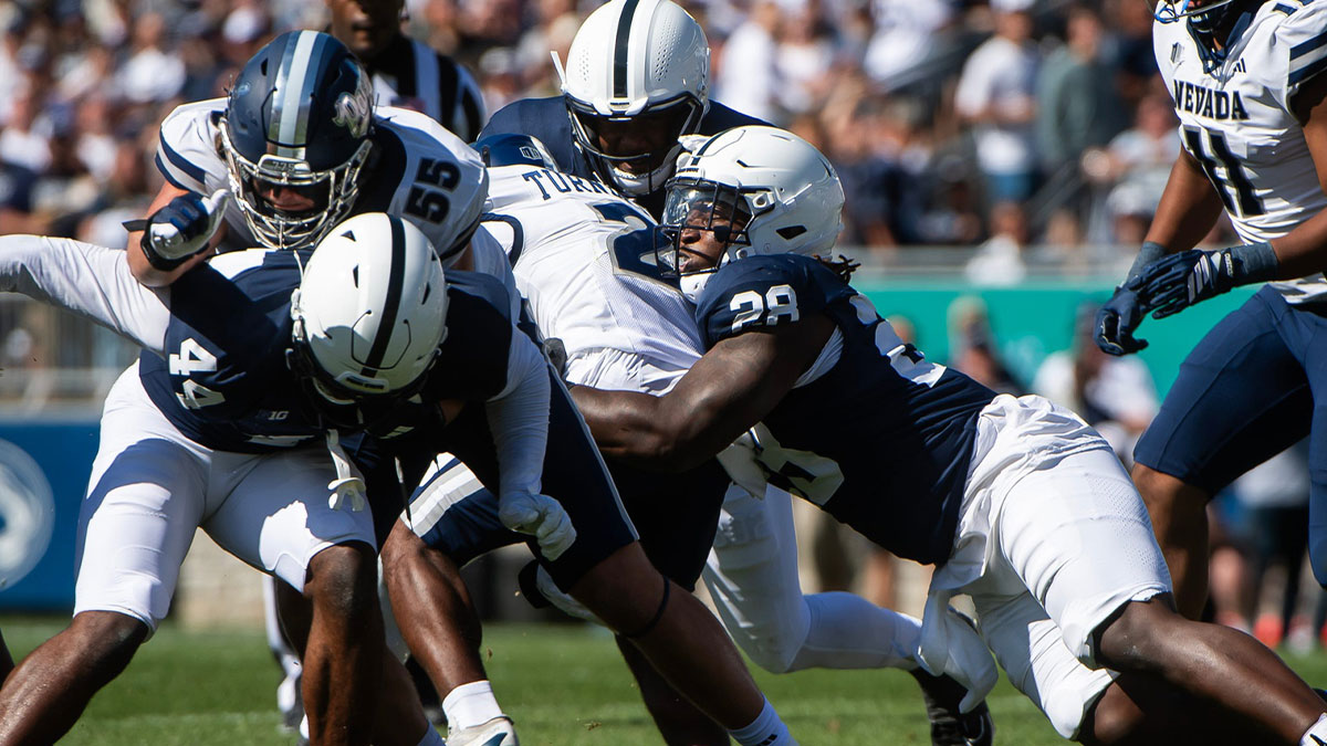 Penn State defensive tackle Zane Durant (28) tackles Nevada running back Herschel Turner (2) in the first half of an NCAA football game, Saturday, August 30, 2025, in State College, Pa.