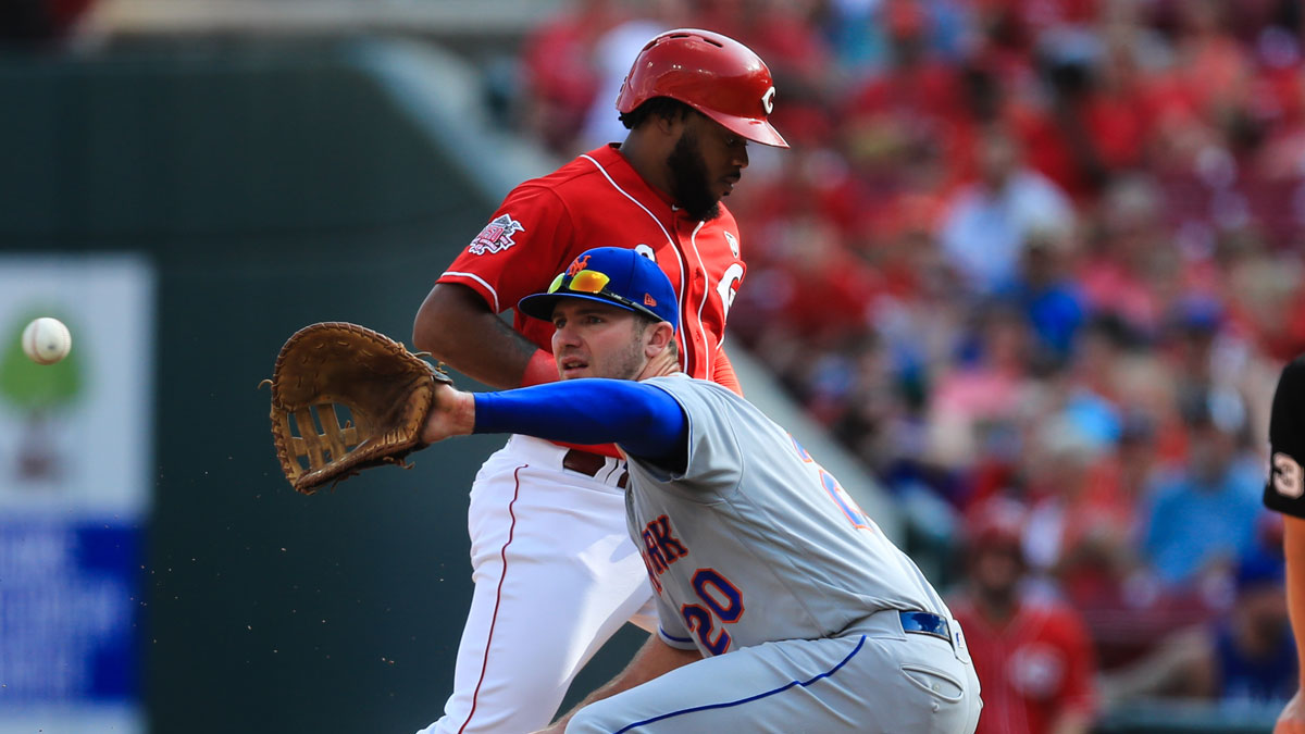 New York Mets first baseman Pete Alonso (20) defends the base against Cincinnati Reds right fielder Phillip Ervin (6) at Great American Ball Park.