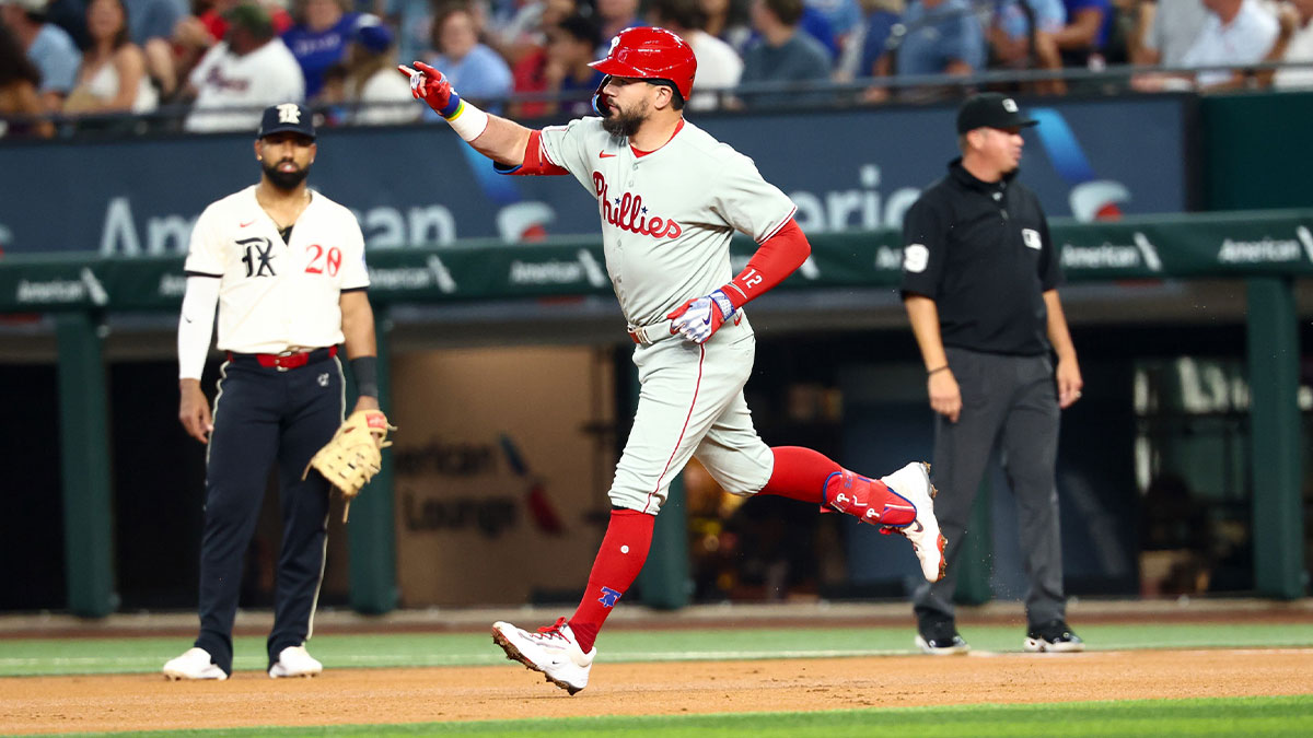 Philadelphia Phillies designated hitter Kyle Schwarber (12) runs past Texas Rangers second baseman Marcus Semien (2) after hitting a home run during the first inning at Globe Life Field.
