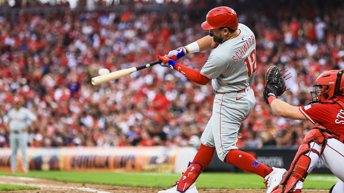 Philadelphia Phillies designated hitter Kyle Schwarber (12) hits a two-run home run in the eighth inning against the Cincinnati Reds at Great American Ball Park.