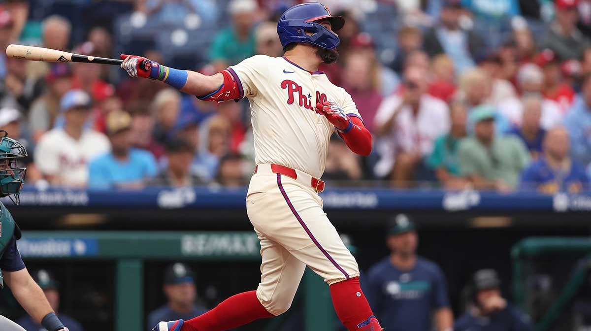 Philadelphia Phillies outfielder Kyle Schwarber (12) hits an RBI sacrifice fly during the first inning against the Seattle Mariners at Citizens Bank Park.
