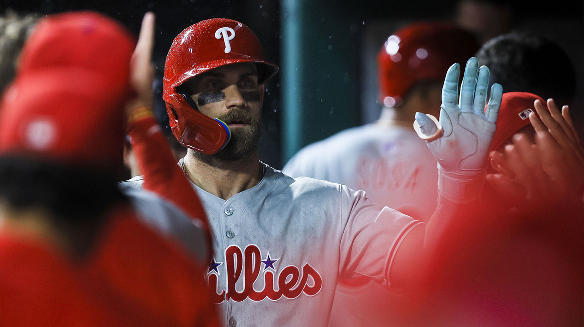Philadelphia Phillies first baseman Bryce Harper (3) high fives teammates after hitting a solo home run in the ninth inning against the Cincinnati Reds at Great American Ball Park.
