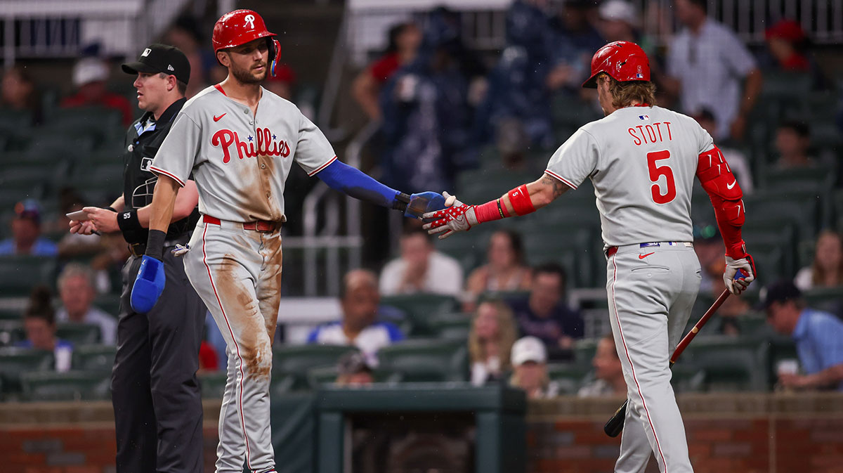 Philadelphia Phillies shortstop Trea Turner (7) celebrates with second baseman Bryson Stott (5) after scoring a run against the Atlanta Braves in the first inning at Truist Park.