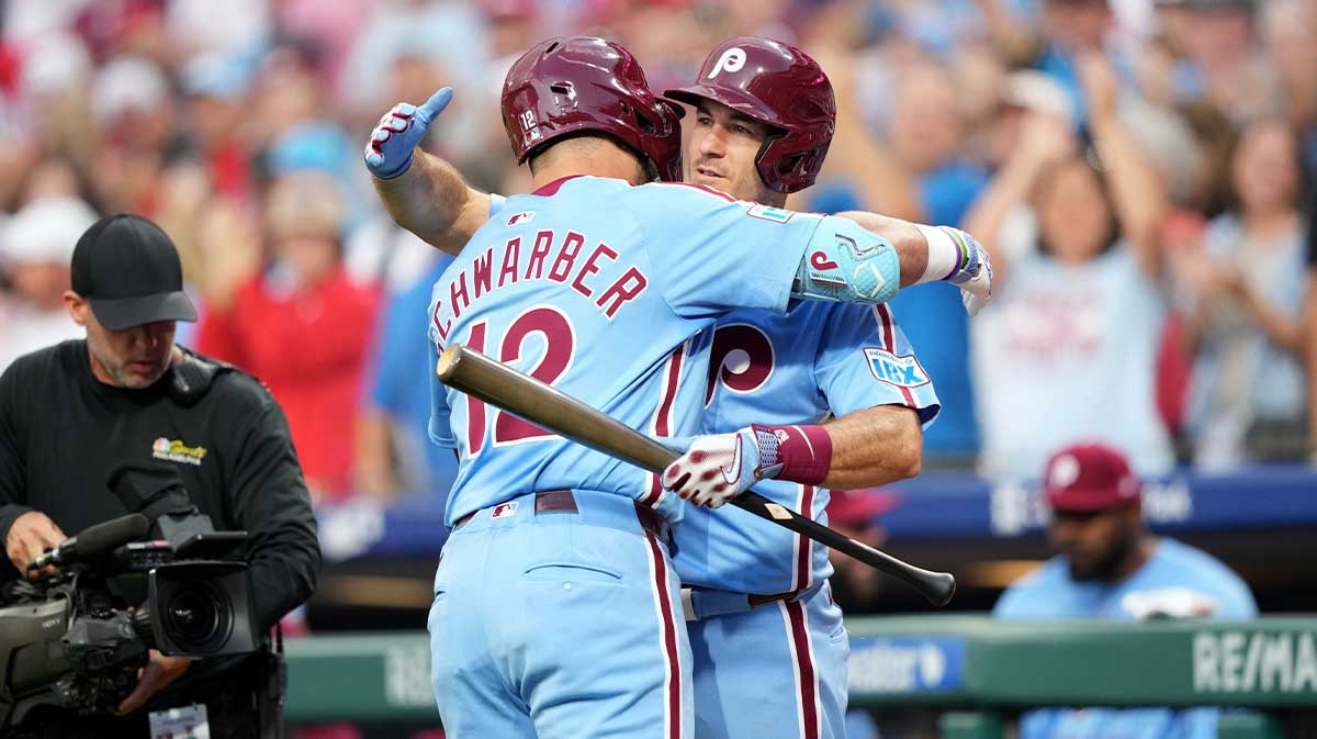Aug 28, 2025; Philadelphia, Pennsylvania, USA; Philadelphia Phillies designated hitter Kyle Schwarber (12) reacts with catcher J.T. Realmuto (10) after hitting a home run against the Atlanta Braves in the first inning at Citizens Bank Park.
