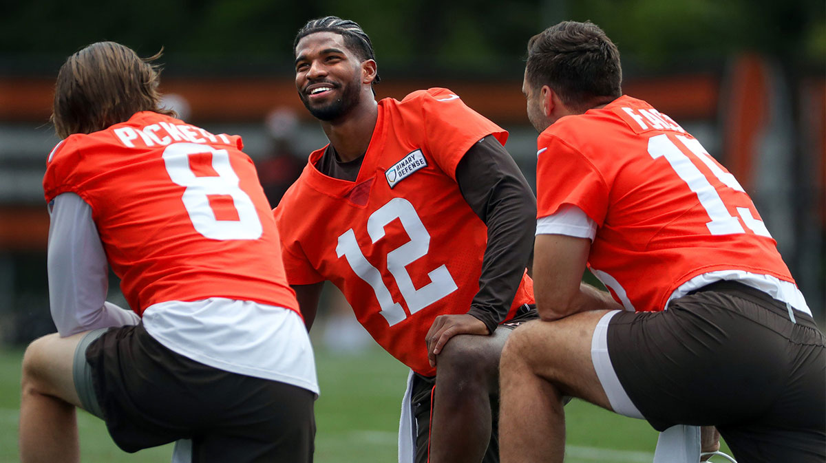 Browns quarterbacks Shedeur Sanders (12), Kenny Pickett (8) and Joe Flacco (15) talk during minicamp June 10, 2025, in Berea.