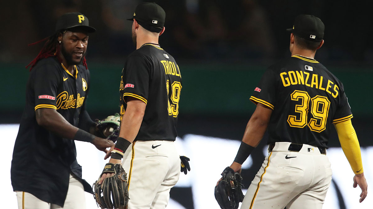 Pirates center fielder Oneil Cruz (left) and shortstop Jared Triolo (19) and second baseman Nick Gonzales (39) celebrate after defeating the Cincinnati Reds at PNC Park
