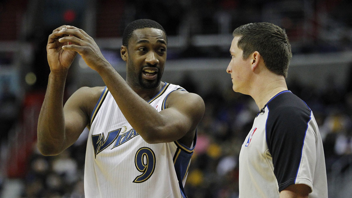 Wizards point guard Gilbert Arenas (9) talks to an official against the Los Angeles Lakers at Verizon Center with Kwame Brown in the background
