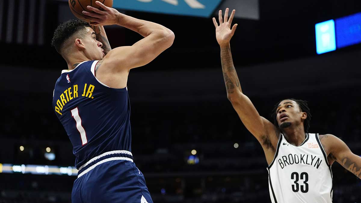 Brooklyn Nets center Nic Claxton (33) defends on Denver Nuggets forward Michael Porter Jr. (1) in first quarter at Ball Arena