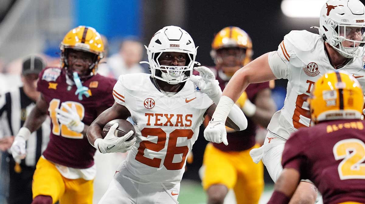 Texas Longhorns running back Quintrevion Wisner (26) runs with the ball against the Arizona State Sun Devils during the first half of the Peach Bowl at Mercedes-Benz Stadium.