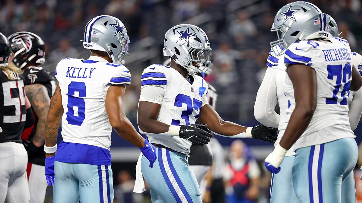 Dallas Cowboys running back Phil Mafah (37) celebrates with teammates after scoring a touchdown during the second half against the Atlanta Falcons at AT&T Stadium.