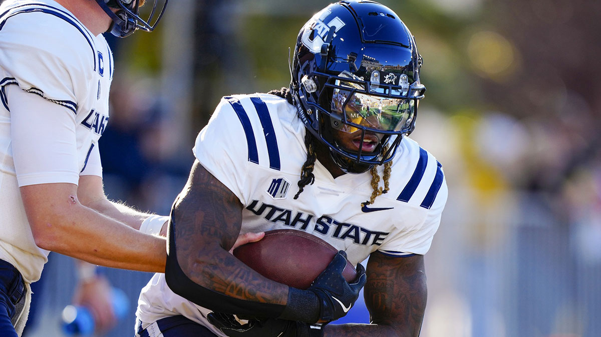 Laramie, Wyoming, USA; Utah State Aggies running back Rahsul Faison (3) warms up before the game against the Wyoming Cowboys at Jonah Field at War Memorial Stadium