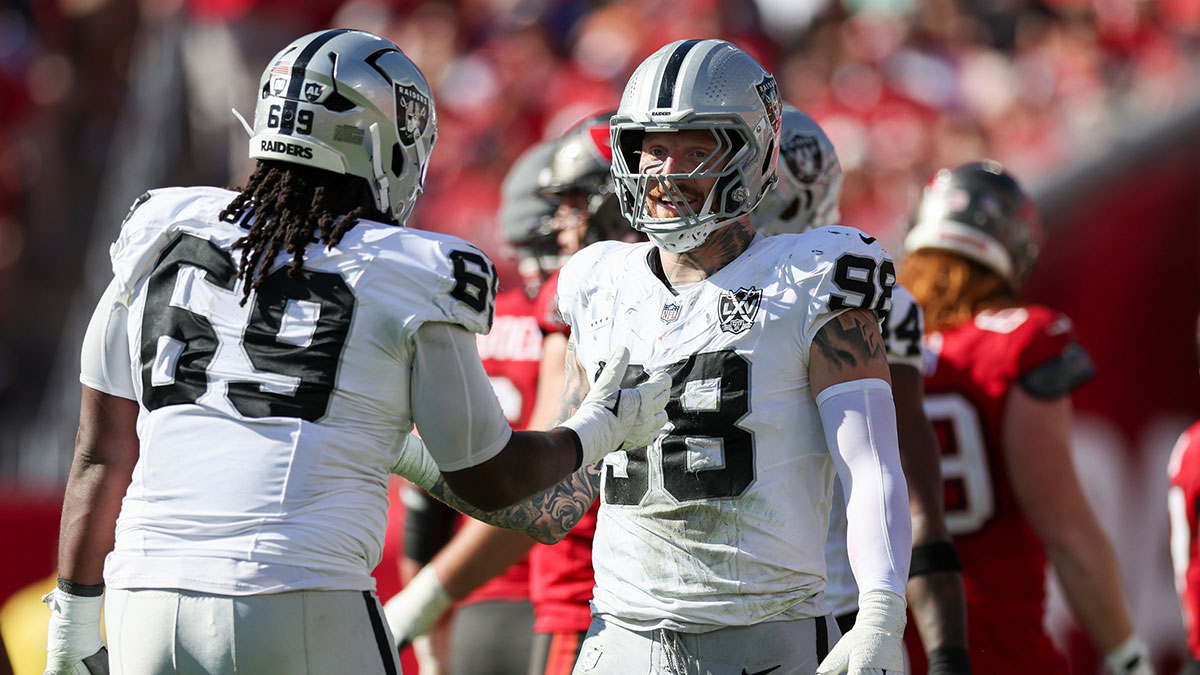 Las Vegas Raiders defensive end Maxx Crosby (98) and defensive tackle Adam Butler (69) reacts after a play against the Tampa Bay Buccaneers in the second quarter at Raymond James Stadium.