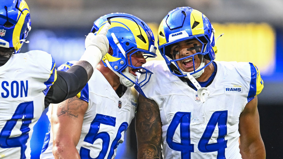 Los Angeles Rams linebacker Shaun Dolac (56) and linebacker Brennan Jackson (44) react after blocking a pass against the Los Angeles Chargers during the second quarter at SoFi Stadium.
