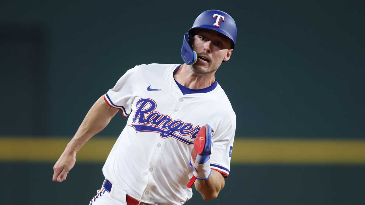 Texas Rangers outfielder Evan Carter (32) rounds third base to score a run against the Colorado Rockies during the fifth inning at Globe Life Field.