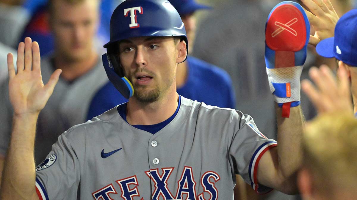 Texas Rangers center fielder Evan Carter (32) in the dugout after scoring a run in the eighth inning against the Los Angeles Angels at Angel Stadium.