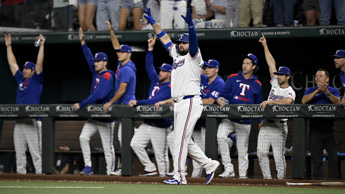 Texas Rangers first baseman Rowdy Tellez (44) celebrates with the team bench as Rangers pinch hitter Jake Burger (not pictured) hits a single and drives in the game winning run against the Arizona Diamondbacks during the tenth inning at Globe Life Field.
