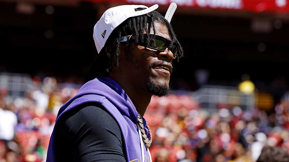 Baltimore Ravens quarterback Lamar Jackson (8) walks on the field before the game against the Washington Commanders at Northwest Stadium.