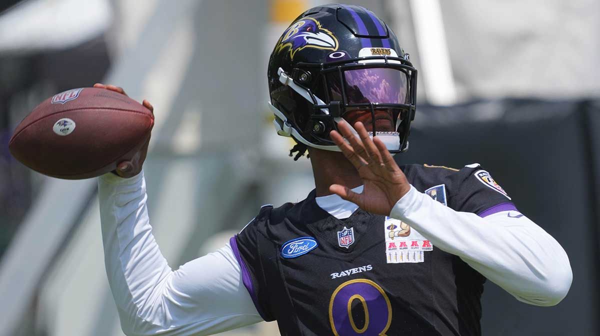 Baltimore Ravens quarterback Lamar Jackson (8) warms up during training camp at Under Armour Performance Center.