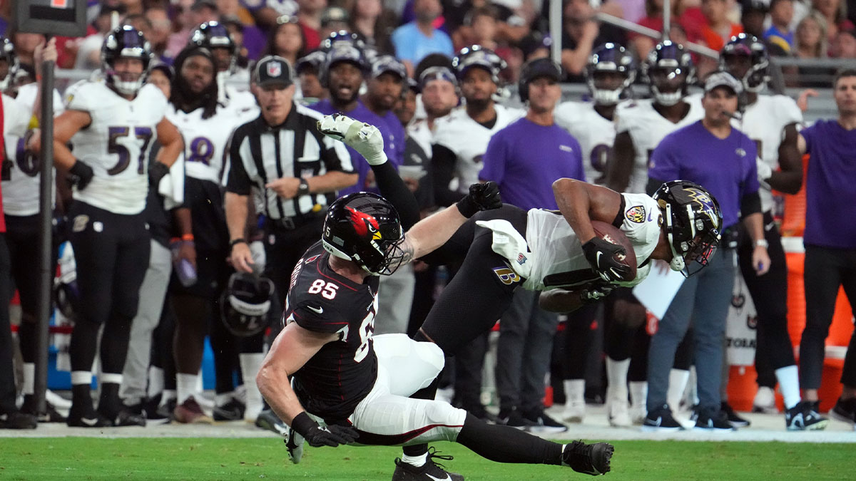 Baltimore Ravens cornerback Kyle Fuller (18) intercepts a pass intended for Arizona Cardinals wide receiver Andre Baccellia (82) during the first half at State Farm Stadium.
