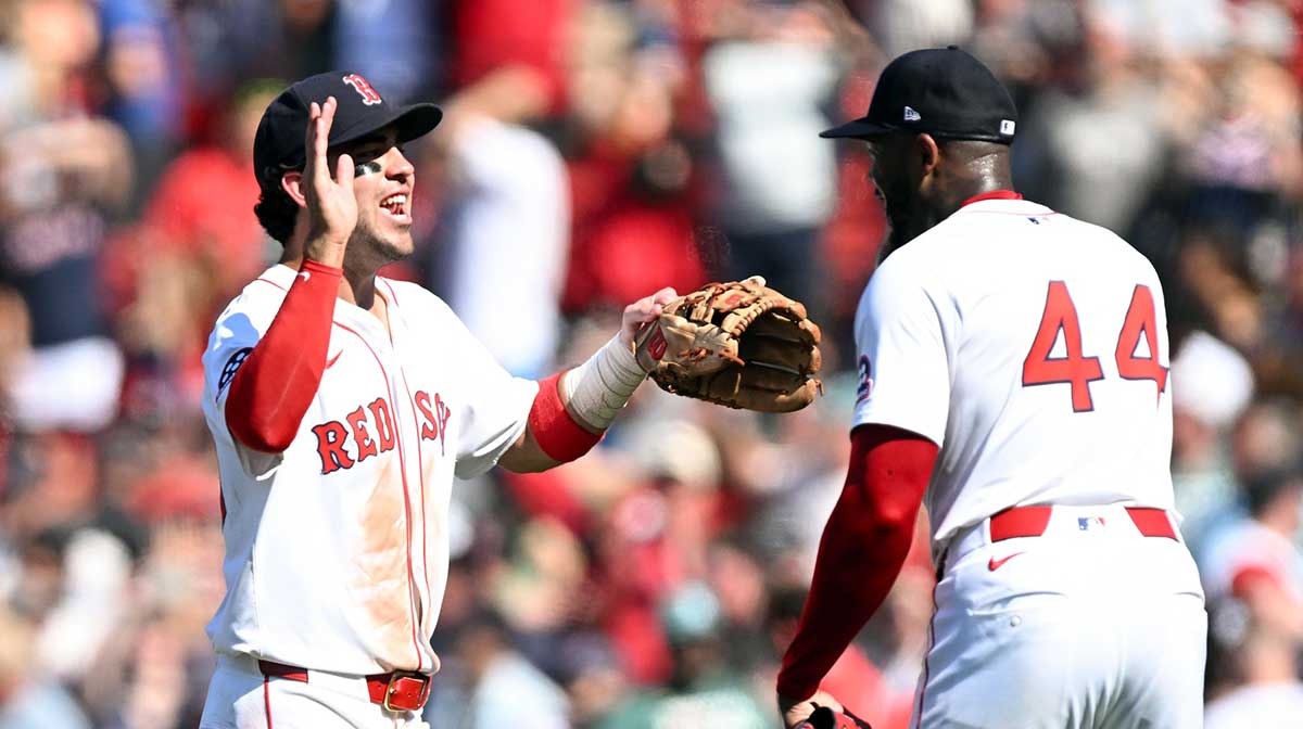 Boston Red Sox pitcher Aroldis Chapman (44) high-fives third base Marcelo Mayer (39) after a game against the Tampa Bay Rays at Fenway Park.