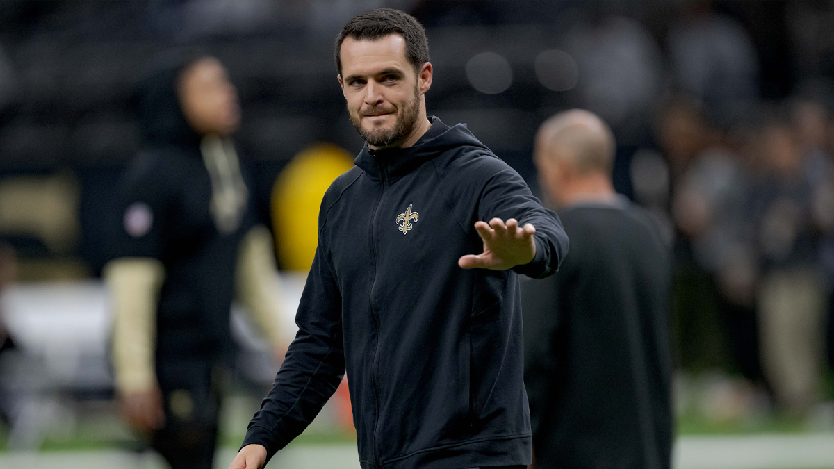 Derek Carr (4) walks the field before a game against the Las Vegas Raiders at Caesars Superdome with Browns quarterback Shedeur Sanders in the background