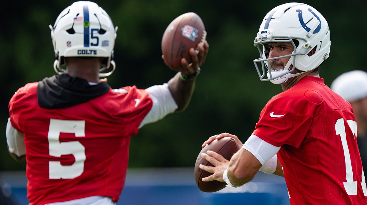Indianapolis Colts quarterbacks Anthony Richardson Sr. (5) and Daniel Jones (17) pass Friday, July 25, 2025, during training camp held at Grand Park in Westfield.
