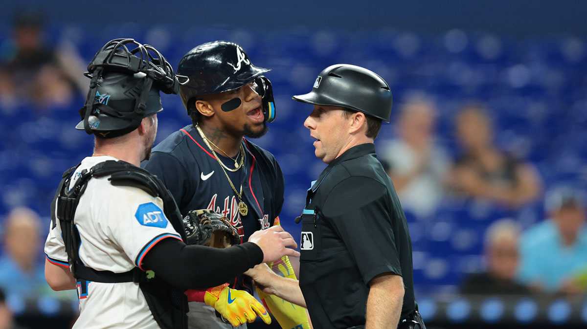 Aug 27, 2025; Miami, Florida, USA; Atlanta Braves designated hitter Ronald Acuna (13) is held back by home plate umpire Tyler Jones (39) after a hit by pitch against the Miami Marlins during the third inning at loanDepot Park.