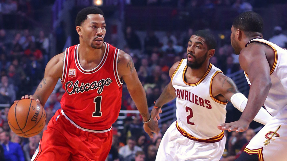 Chicago Bulls guard Derrick Rose (1) drives past Cleveland Cavaliers guard Kyrie Irving (2) during the first quarter at the United Center.