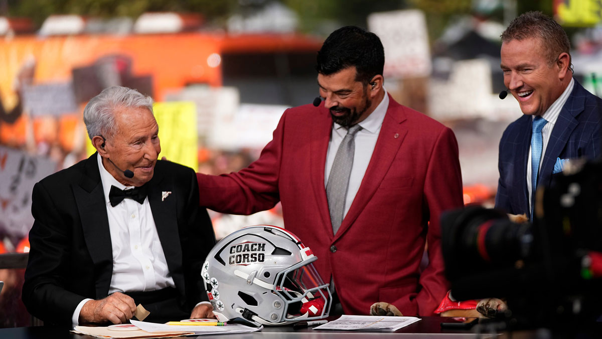 Ohio State Buckeyes head coach Ryan Day presents Lee Corso with a helmet beside Kirk Herbstreit on the set of ESPN College GameDay prior to the NCAA football game between the Ohio State Buckeyes and the Texas Longhorns at Ohio Stadium on Aug. 30, 2025.