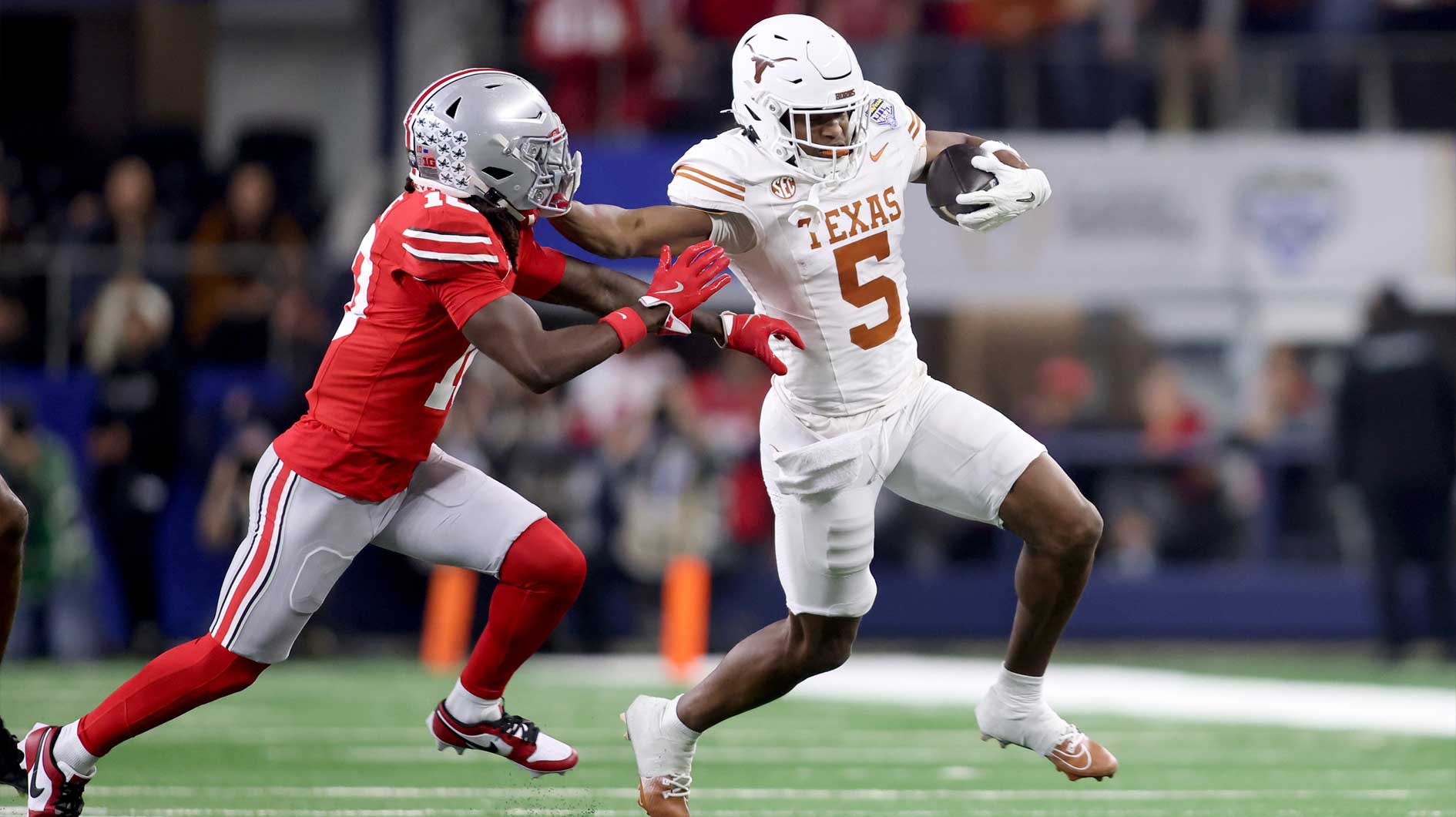 Texas Longhorns wide receiver Ryan Wingo (5) runs against Ohio State Buckeyes cornerback Denzel Burke (10) during the first quarter of the College Football Playoff semifinal in the Cotton Bowl at AT&T Stadium.