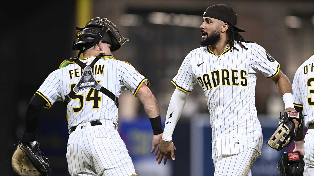 San Diego Padres right fielder Fernando Tatis Jr. (23) and Freddy Fermin (54) celebrate after the Padres beat the Los Angeles Dodgers at Petco Park.