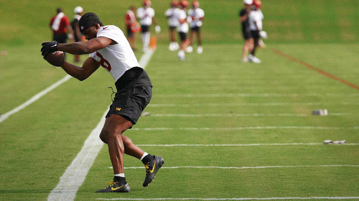 Washington Commanders running back Brian Robinson Jr. (8) catches a ball during practice on day one of training camp at OrthoVirginia Training Center at Commanders Park.