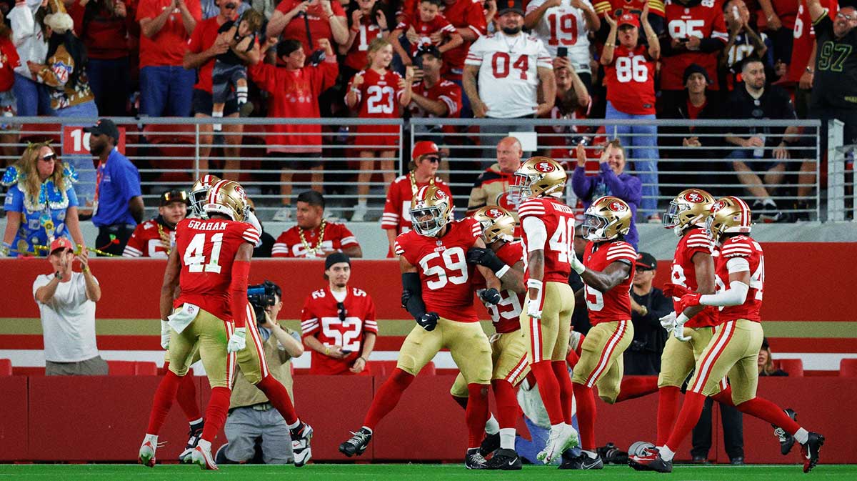 San Francisco 49ers linebacker Curtis Robinson (59) celebrates with teammates after returning an interception for a touchdown during the fourth quarter against the Los Angeles Chargers at Levi's Stadium.