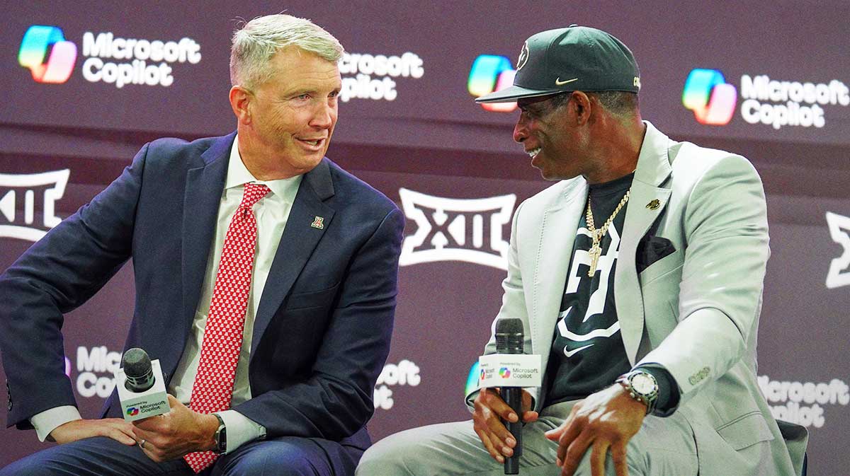 Arizona head coach Brent Brennan and Colorado head coach Deion Sanders talk on stage during 2025 Big 12 Football Media Days at The Star.