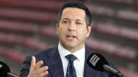 Adam Schefter talks on a set before the 2024 College Football Playoff national championship game between the Michigan Wolverines and the Washington Huskies at NRG Stadium.