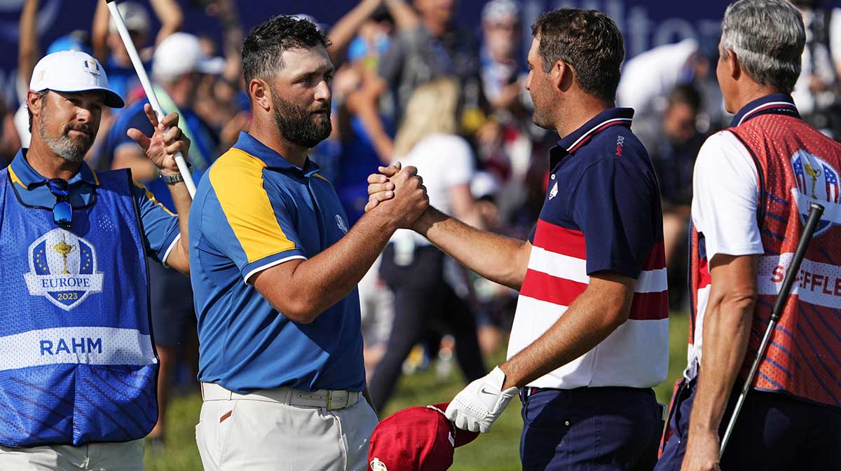 Team Europe golfer Jon Rahm and Team USA golfer Scottie Scheffler shake hands on the 18th green during the final day of the 44th Ryder Cup golf competition at Marco Simone Golf and Country Club