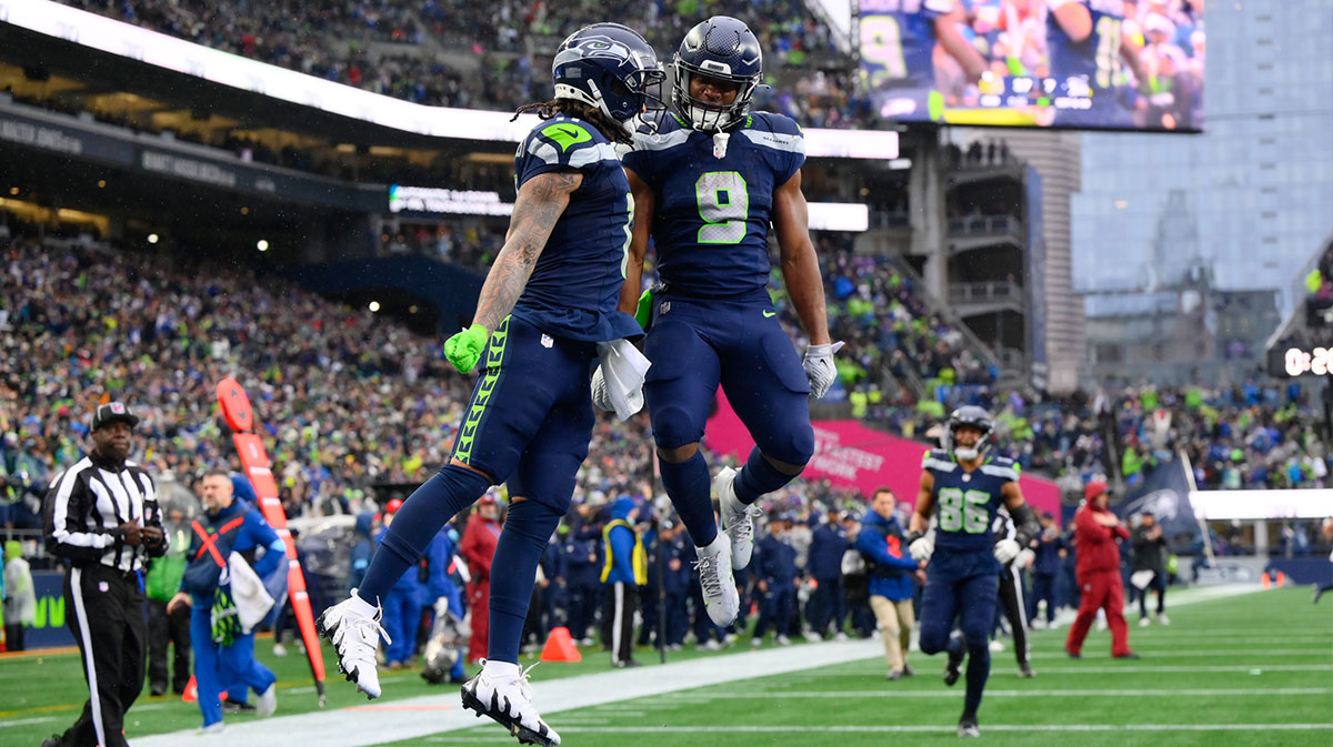 Seattle Seahawks wide receiver Jaxon Smith-Njigba (11) and running back Kenneth Walker III (9) celebrate after Jaxon Smith-Njigba scored a touchdown against the Minnesota Vikings during the first half at Lumen Field.