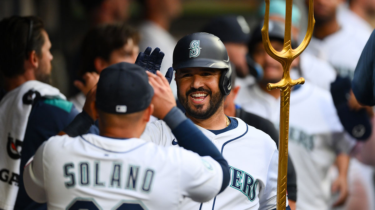 Seattle Mariners third baseman Eugenio Suarez (28) celebrates in the dugout after hitting a 2-run home run against the Chicago White Sox during the fourth inning at T-Mobile Park.