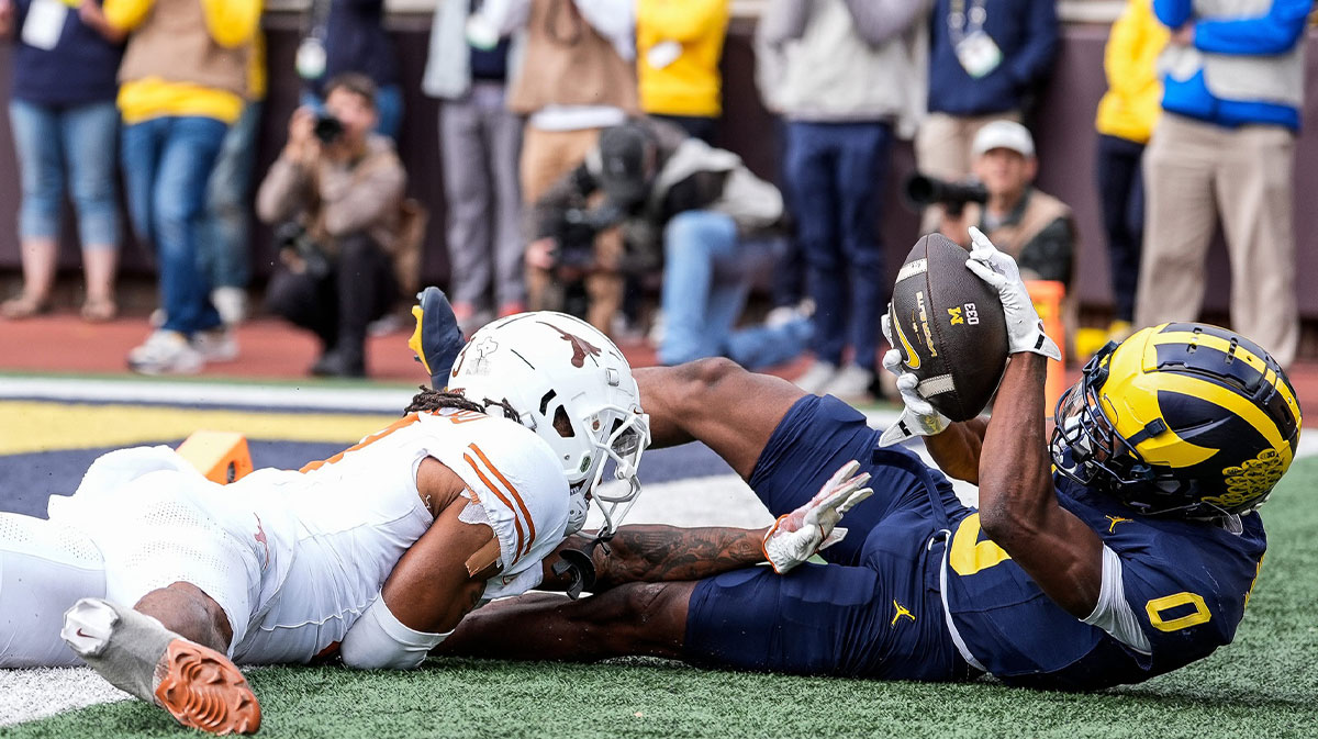 Michigan wide receiver Semaj Morgan (0) makes a catch for a touchdown against Texas defensive back Jaylon Guilbeau (3) during the second half at Michigan Stadium